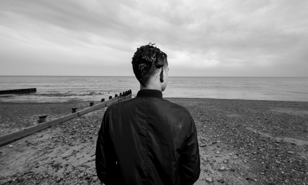 Young boy looking out to sea