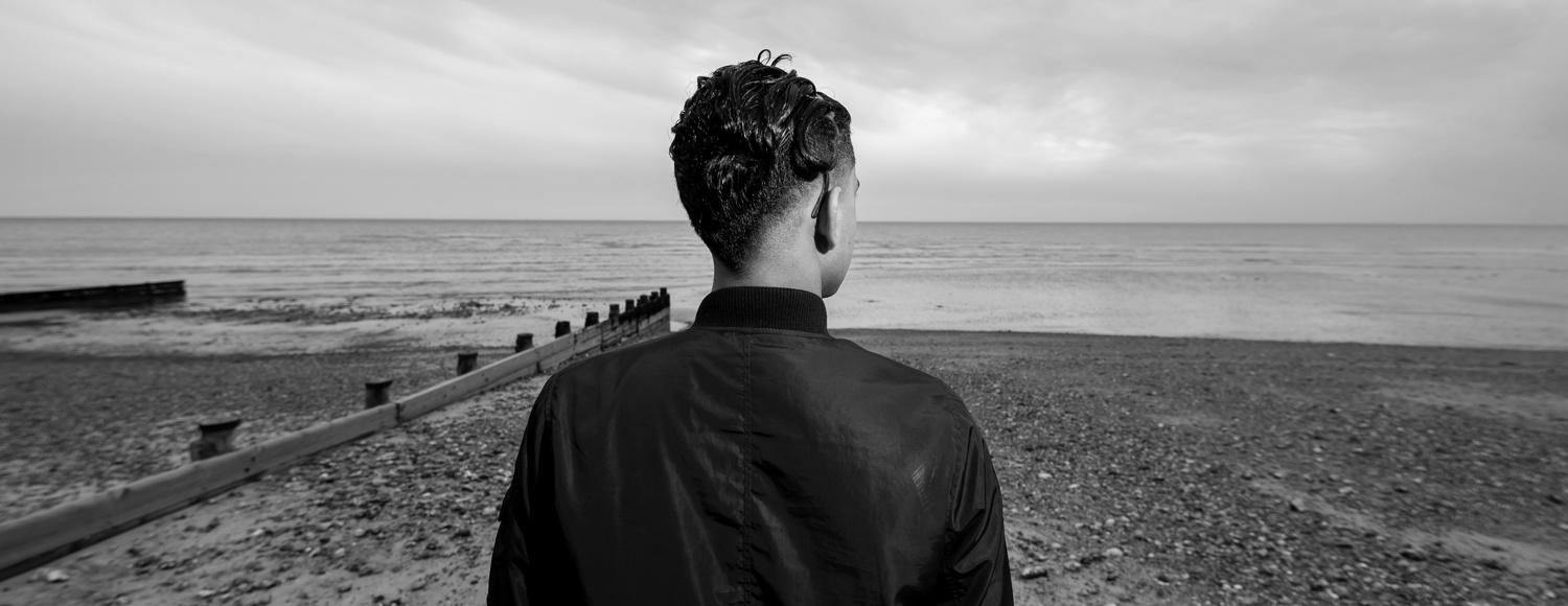 Young boy looking out to sea