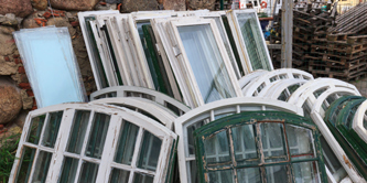 A number of window panes stacked against each other.