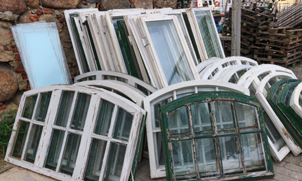 A number of window panes stacked against each other.