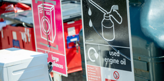 A used engine oil sign at a recycling centre.