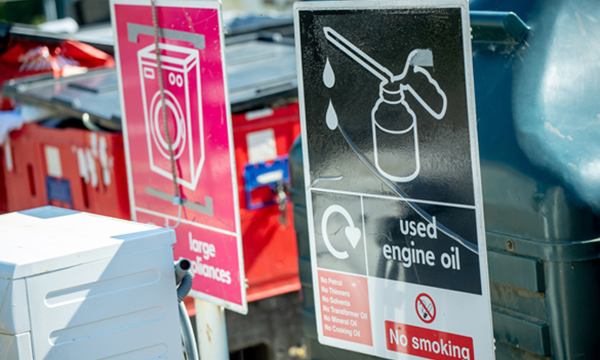 A used engine oil sign at a recycling centre.