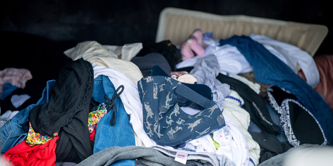 Clothes and other textiles in a textile container in a recycling centre.