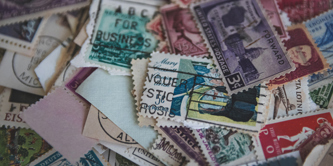 Lots of different postage stamps overlapping each other.