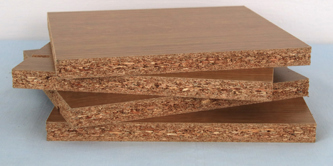 A pile of 4 pieces of chipboard.