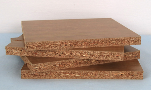 A pile of 4 pieces of chipboard.