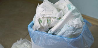 A bin full of disposable nappies.