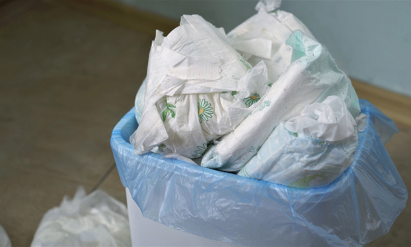 A bin full of disposable nappies.