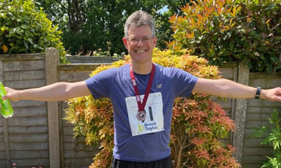 Simon, smiling after running a marathon