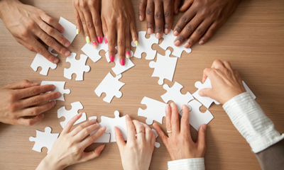 Group of people doing a jigsaw