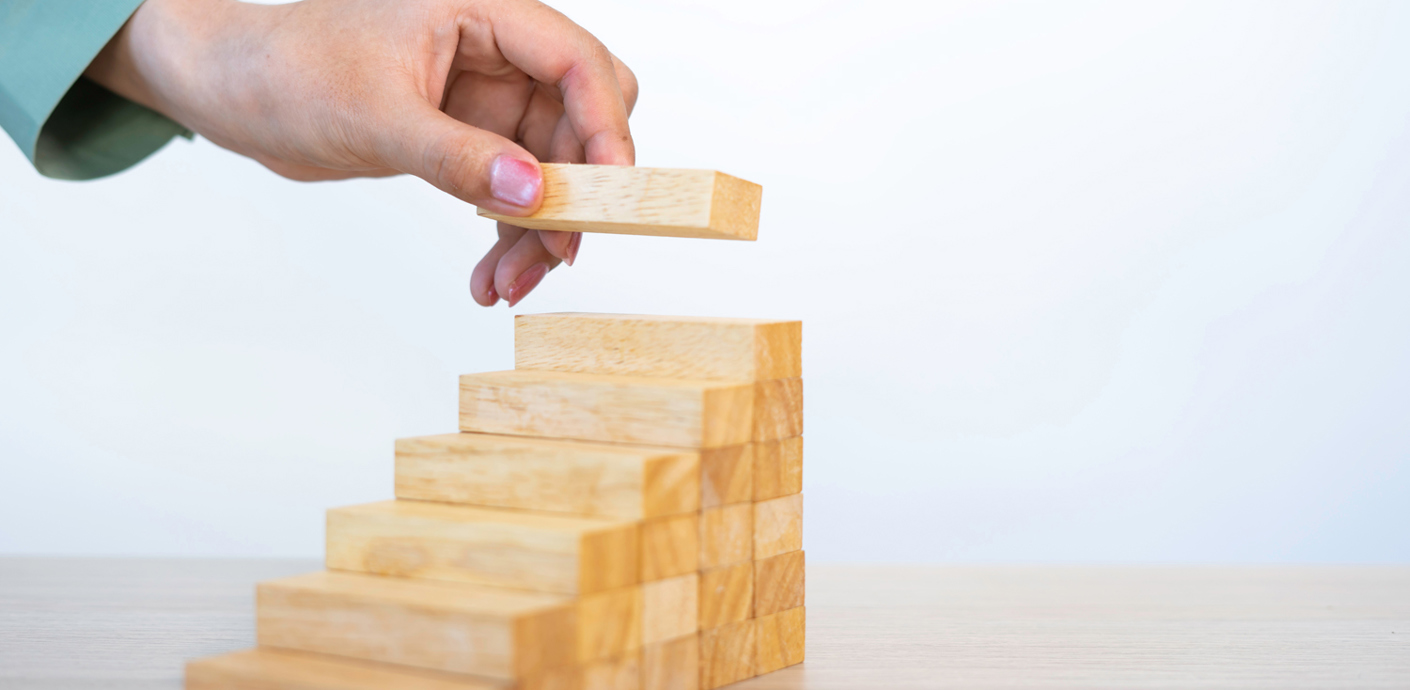 nojs Wooden blocks stacked to look like steps with a the last one to put in place at the top.
