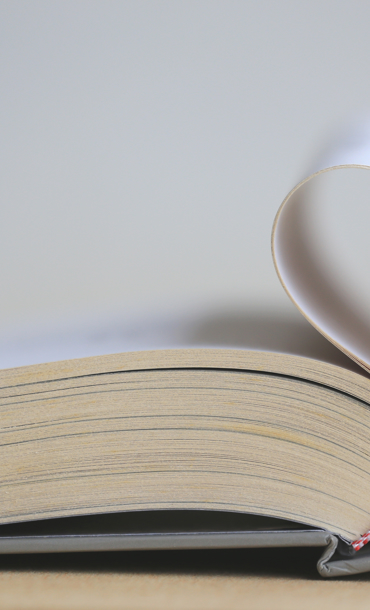 Pages of a book folded into a heart.