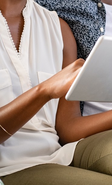 Couple paying for a booking on a tablet.