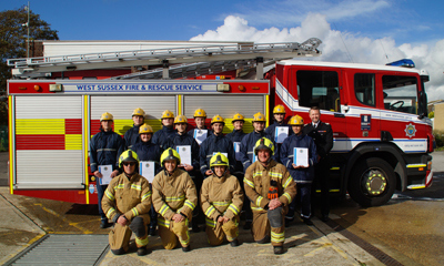 Firefighters in front of fire engine