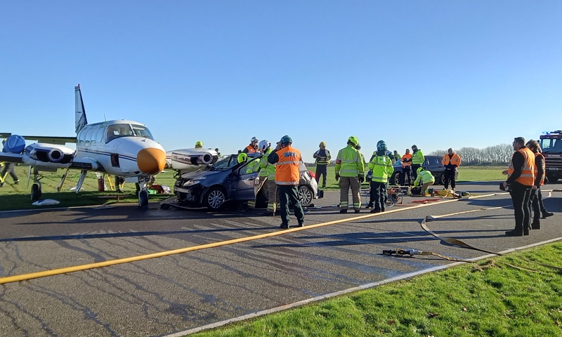 Fire service personnel attend an aircraft collision on a race track