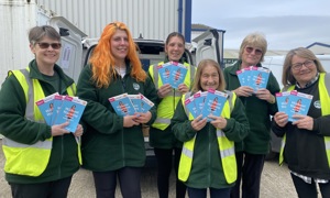 HILS Community Team members delivering books with their clients' hot meals