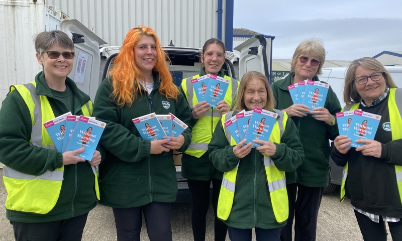 HILS Community Team members delivering books with their clients' hot meals