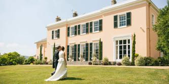Bride and groom in front of Bignor Park House