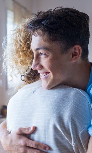 Adult and child hugging