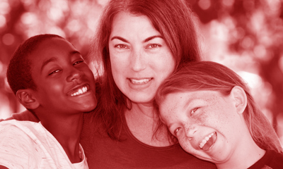 Woman hugging two children