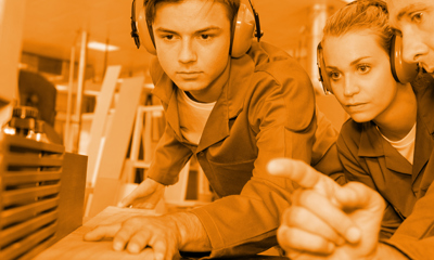 Young people wearing ear defenders