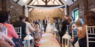 Couple at top of aisle at Selden Barn.
