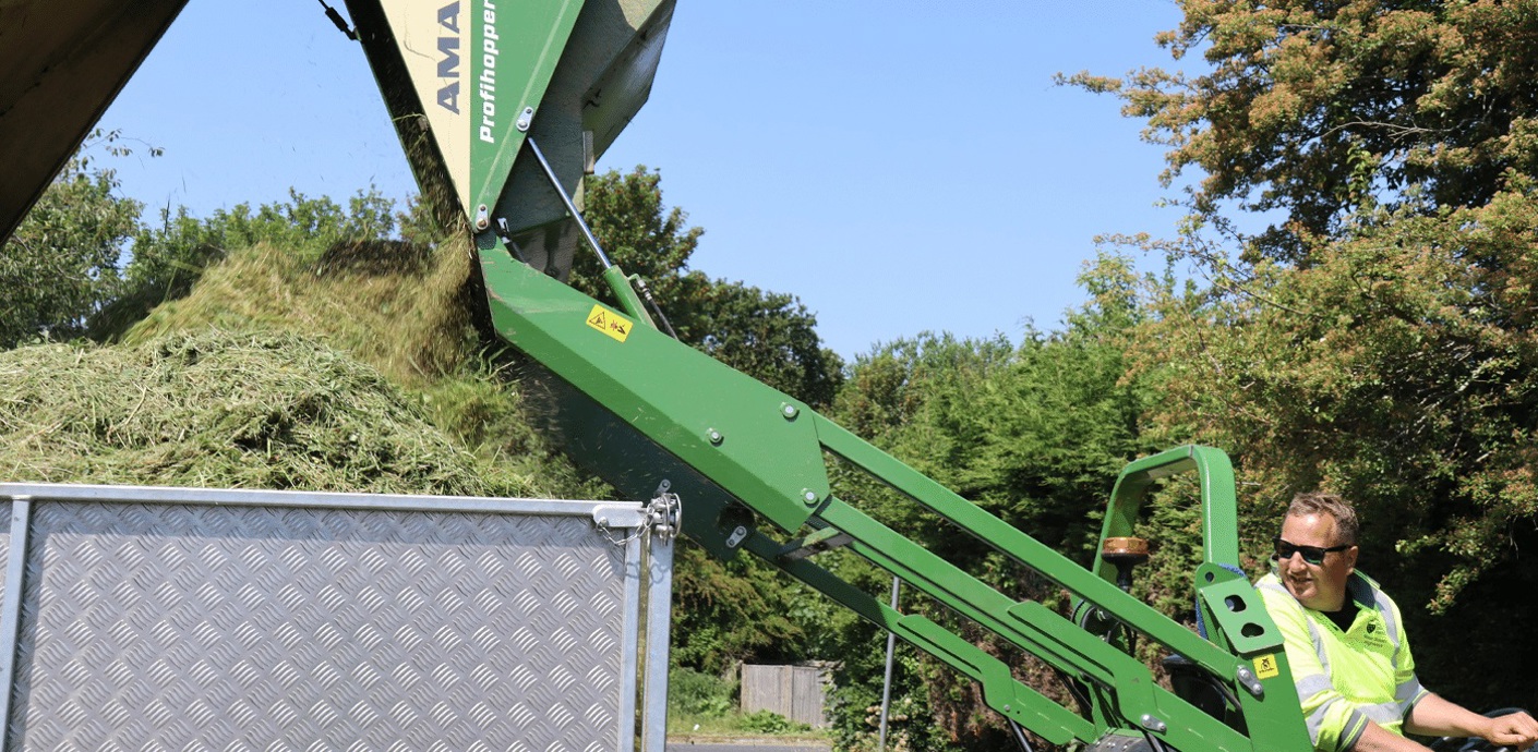 nojs Grass being emptied in to a large container