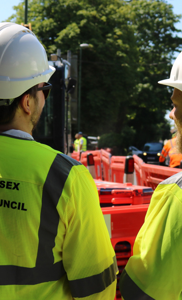 Two workmen wearing hard hats