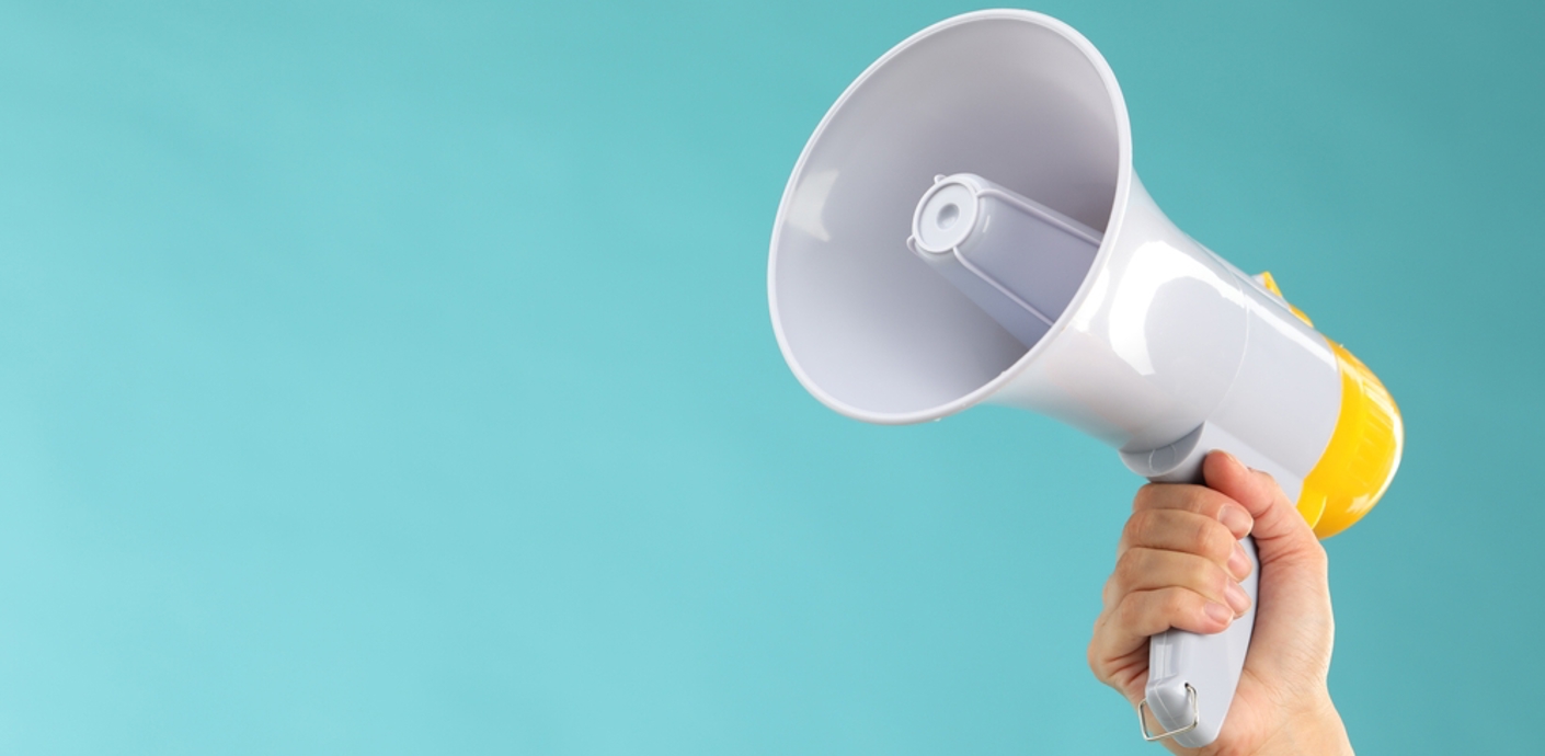 nojs Person's hand holding up a megaphone.