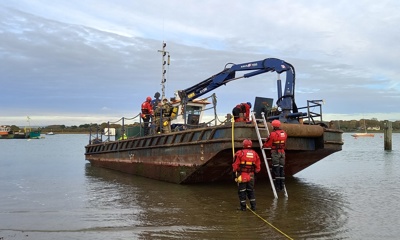Crews tackle a simulated fire on a barge