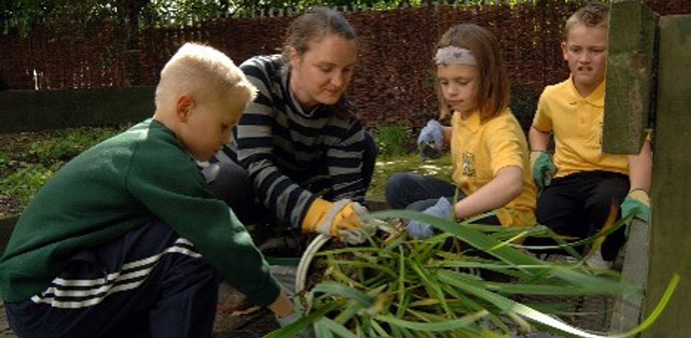nojs Woman and three children in a garden