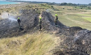 Firefighters damping down the landscape after a fire at West Beach Littlehampton