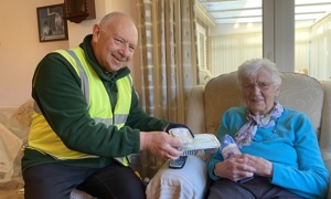 Mrs Barbara Platt, 93, receiving her wheat bag from community team member Phil Cooling.