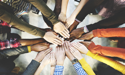 Group of people with outstretched arms